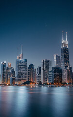 Naklejka premium Night cityscape with blue and white colors modern architecture urban city life night skyline 