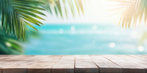 Fototapeta premium Summer background with a wooden table top and a tropical beach, palm tree leaves on a sea-blue ocean, and a sunlight bokeh effect.