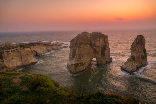 The scenic view of Pigeons' Rock (Raouche rocks), Beirut landmark on the Mediterranean sea coast, during the beautiful sunset.
