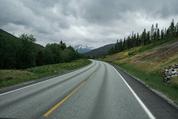Empty road in a moody norway mountain landscape
