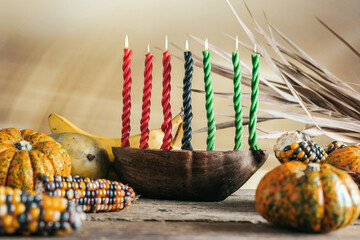 Kwanzaa, african holiday Kwanzaa with decoration of seven candles in red, black and green colors, vegetable harvest, corn. Greeting card banner. Happy Kwanzaa