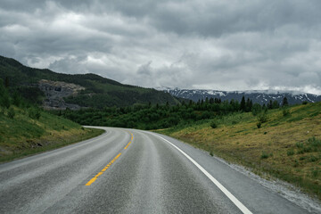 Empty road in a moody norway mountain landscape
