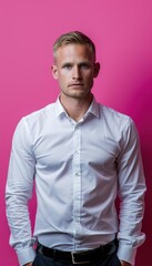 Obraz premium Confident Businessman in White Shirt Against Vivid Pink Background for Professional Portraits