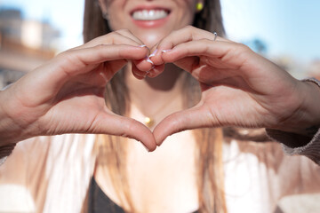 Woman Making Heart Shape with Hands