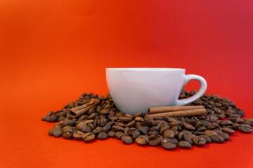 Cup of coffee on the coffee beans with cinnamon background
