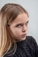 Portrait of a girl expressing negative emotions with intense gaz
