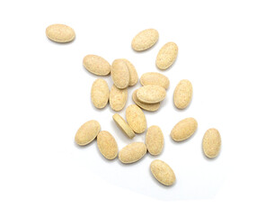 Brown pills, medicine isolated on white background, top view