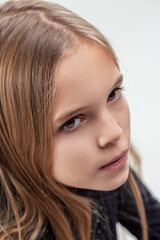 Portrait of curious young girl looking up with thoughtful expres