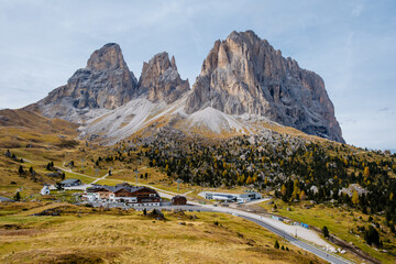 Majestic peaks of the Dolomites rise above charming alpine village on a clear day