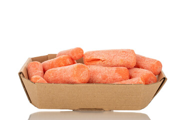 Several peeled small carrots in a paper plate, macro, isolated on white background.