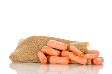 Several peeled small carrots with jute bag, macro, isolated on white background.