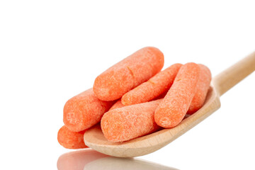 Several peeled small carrots with wooden spoon, macro, isolated on white background.