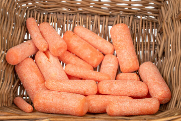 Several peeled small carrots in a basket, macro.
