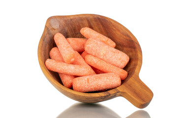 Several peeled small carrots with wooden utensils, macro, isolated on white background.