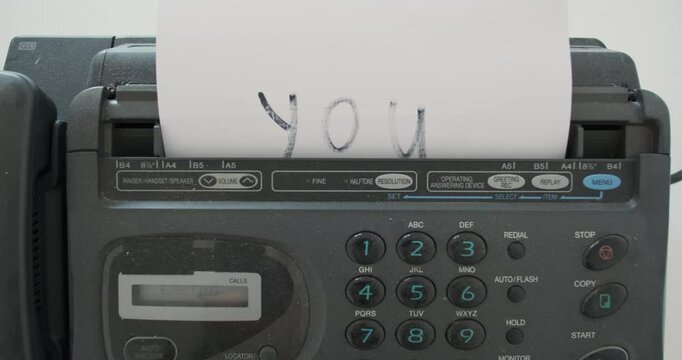 Boss sends message you fired by old retro fax. Retro office device, sheet of paper with a notice of layoffs. Concept of downsizing, retro device for sending messages via telephone cable.