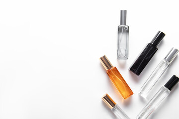 Different perfume bottles on white background. Free space for text