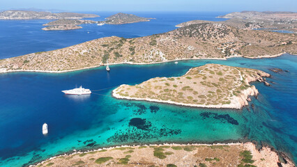 Aerial drone photo of yachts and sail boats anchored in tropical exotic island complex with crystal clear turquoise sea forming a blue lagoon