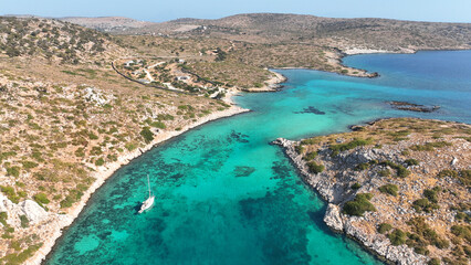Obraz premium Aerial drone photo of yachts and sail boats anchored in tropical exotic island complex with crystal clear turquoise sea forming a blue lagoon