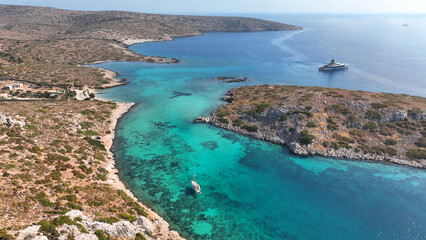 Aerial drone photo of yachts and sail boats anchored in tropical exotic island complex with crystal clear turquoise sea forming a blue lagoon