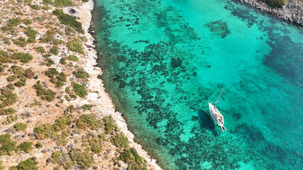 Aerial drone top down photo with copy space of luxury yacht anchored in tropical exotic island with crystal clear turquoise sea