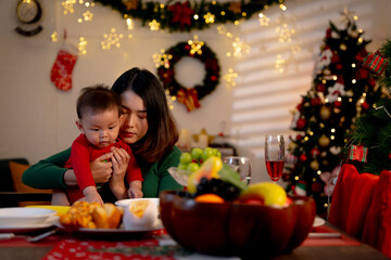 Asian baby and family celebrating Christmas together at home.