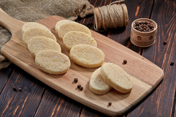 raw cutlets on the wooden board