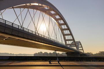 Obraz premium Electric scooter near the New Bridge in Novi Sad, Serbia