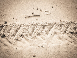 Traces of motorbike on beach.