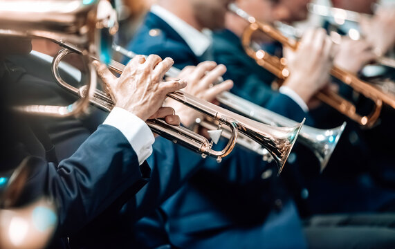 Brass musicians playing the trumpet during a concert