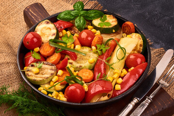 Grilled vegetables ( colorful bell pepper corn, zucchini, eggplant, onion ) on black Cast iron pan.