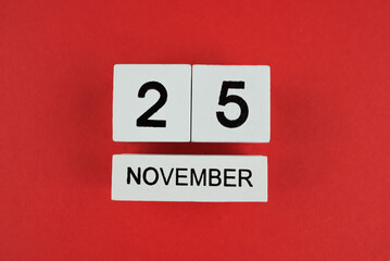 Wooden calendar 2025 with inscription 25 november on red background. Black friday. Top view