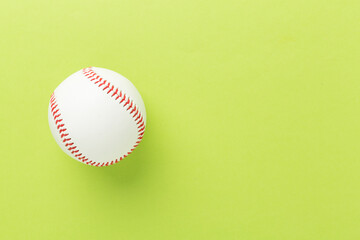 Baseball ball on color background, top view