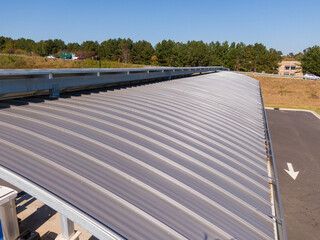 Sunny Daytime Drone Images of New Standing Seam Metal Roof on a Commercial Building