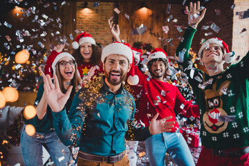 Photo of cheerful young people friends group dancing confetti have fun cheerful smile cozy christmas party decor spacious apartment indoors