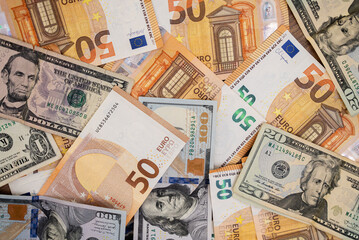 Collection of mixed Euro and US Dollar banknotes spread out. Financial diversity and currency exchange concept 