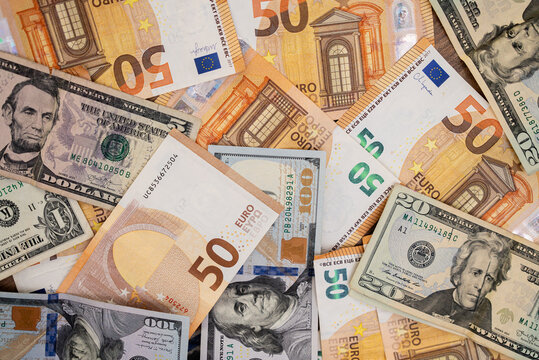 Collection of mixed Euro and US Dollar banknotes spread out. Financial diversity and currency exchange concept 