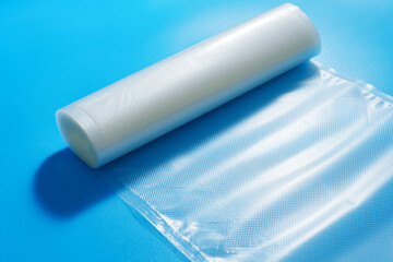 Roll film for a product vacuum sealer machine on a blue background. long-term storage of products...