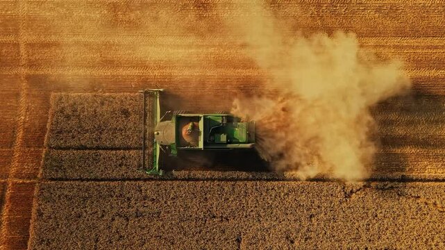 Beautiful Vivid Detail Shot of Harvester Working a Field Tracking Zoom Out Rise Ascend Reveal Perspective Symmetry Agriculture