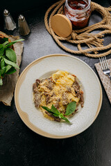 Creamy pasta with beef strips, Parmesan, basil, and sun-dried tomatoes, served in an elegant setting