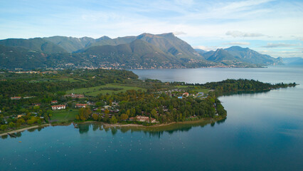 Toscana, Italy, Lake Garda - October 09, 2024: Drone shot in the morning of Lake Garda and the surrounding nature