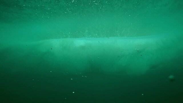 Surfing wave in Bali island. Ocean wave clear water. Uluwatu famous surf destination in Indonesia. Adventure travel. Slow motion.