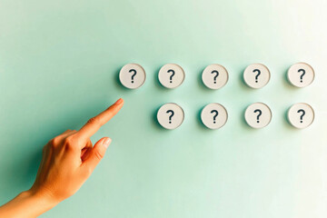 Hand pointing at rows of question mark buttons on light green background