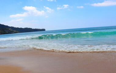 Obraz premium Ocean waves gently washing golden sand, capturing the tranquility of the beach.