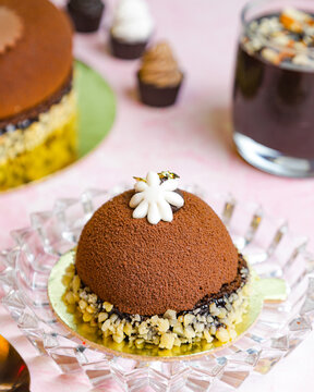 Chocolate mousse pastry on pink surface