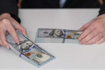 Woman hands holding pile of 100 US dollar banknotes