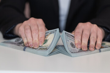 Woman hands holding pile of 100 US dollar banknotes