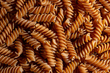 Uncooked Whole Grain Fusilli Pasta: A Culinary Canvas of Whole Wheat Spirals, Creating a Lively and...