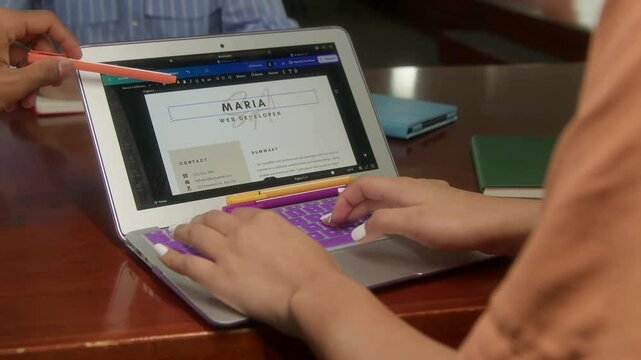 Designing a resume on a laptop screen