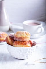 Donuts with sugar and cinnamon served with cocoa. Traditional dessert for Carnival.