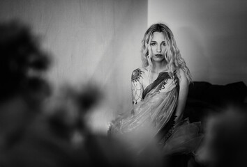 Artistic Portrait of a Woman with Tattooed Shoulders in Soft Light